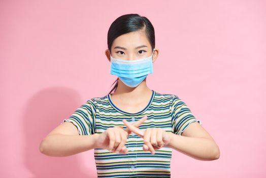 Beaterfull Woman in face surgical mask show stop by finger, gesture for stop corona virus.