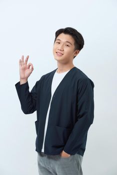 cheerful young man showing ok sign