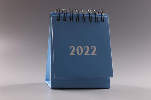 Blue loose leaf calendar 2022 on gray background