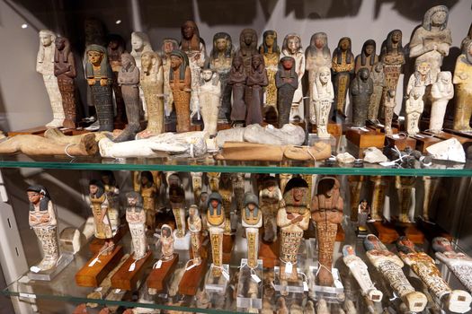 TURIN, ITALY - AUGUST 19, 2021: small votive statuettes during the Egyptian civilization, Egyptian Museum of Turin, Italy