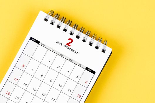 February 2022 desk calendar on yellow