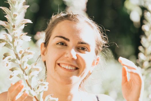 Portrait of a smiling young woman near some flowers, mental health and self care concepts, psychology, young
