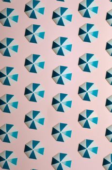 Pattern of blue umbrellas over a pastel pink background, minimalism, design and digital resource, background with copy space