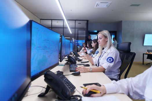 Female security guards working in a security data system control room