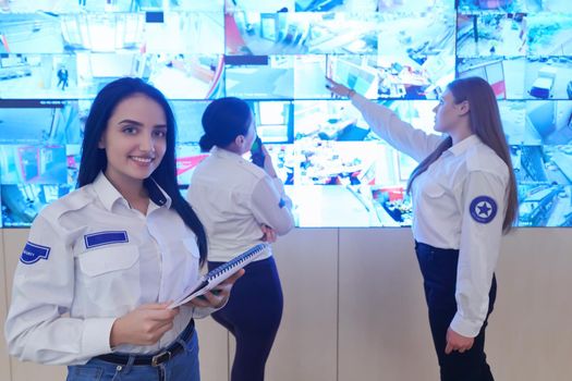 Female security guards working in a security data system control room