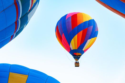 Multicolored air balloon in clear blue sky