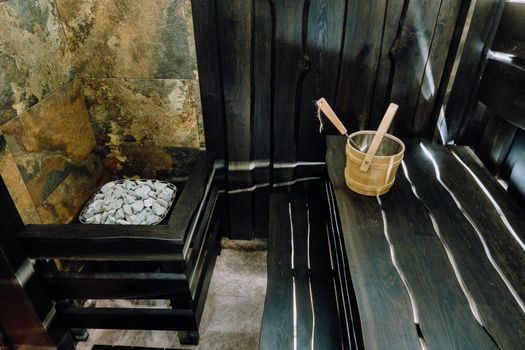 Bucket and ladle in a wooden sauna. Wooden accessories in the sauna