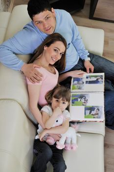 happy family looking photos at home