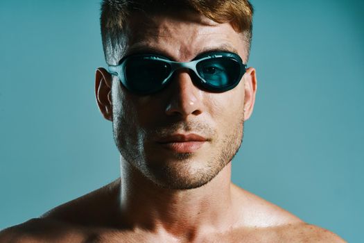 man in swimming goggles athlete swimmer blue background