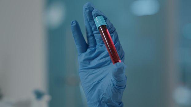 Scientist holding test tube with dna substance in laboratory