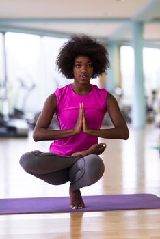 beautiful young african american woman exercise yoga in gym