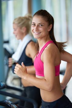 woman exercising on treadmill in gym