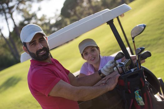 couple in buggy on golf course