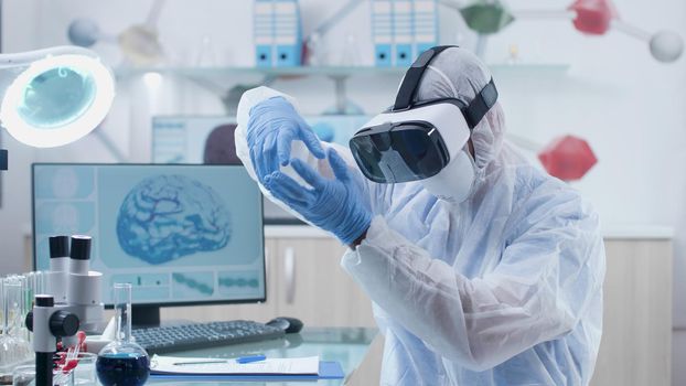 Scientist researcher doctor wearing virtual reality headset during neuroscience experiment