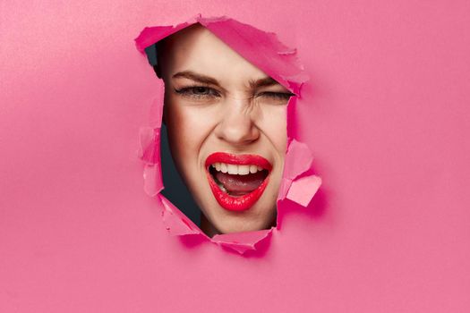 cheerful woman poster hole pink background and red lips
