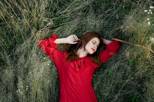 woman in red dress nature green grass landscape rest