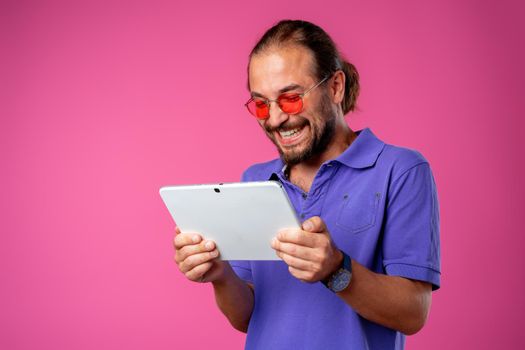 Funny hipster man using his digital tablet