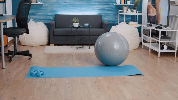 Nobody in living room with sport equipment to exercise