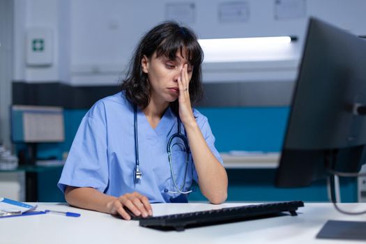 Medical assistant falling asleep while using computer and keyboard
