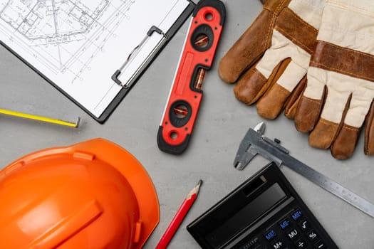 Architect tools hardhat, blueprints and calculator top view