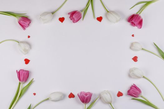 Frame of tulips and red hearts