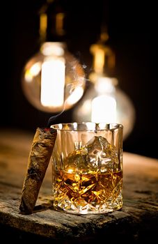 Cigar and glass with whiskey