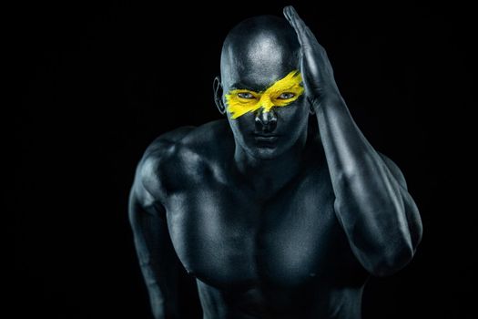 Sprinter and runner man. Running concept. Fitness and sport motivation. Strong and fit athletic, guy in body paint sprinter or runner, running on black background.