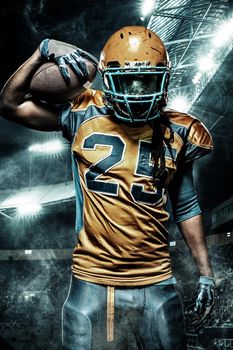 American football sportsman player on stadium with lights on background