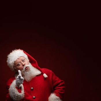 Portrait of funny Santa Claus pointing at you on backgroun with copy space