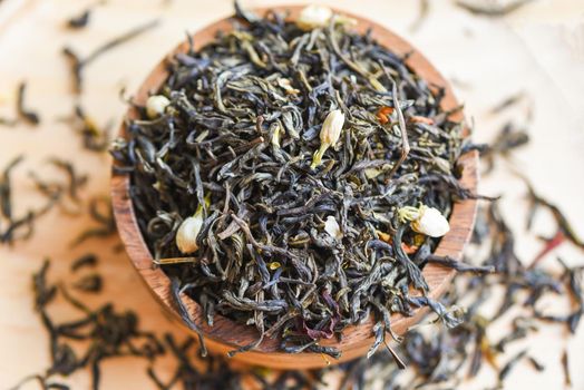 Chinese dry tea on wooden bowl, jasmine tea dried for brew tea, leaf black tea