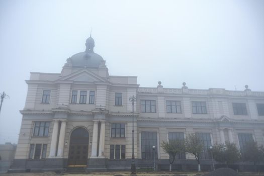Vintage building of railway station in fog weather
