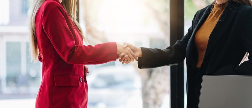two businessman shake hands as hello in office closeup. Friend welcome, introduction, greet or thanks gesture, product advertisement, partnership approval, strike a bargain on deal concept