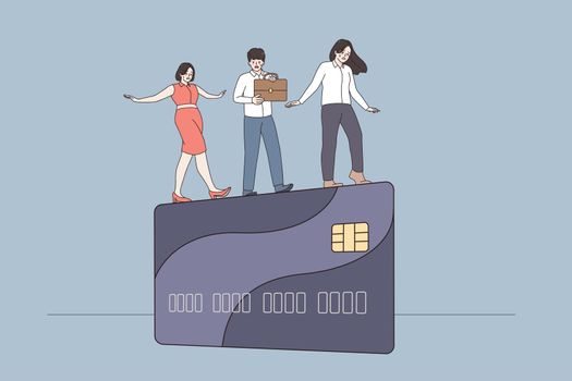 Businesspeople walk on edge of credit card