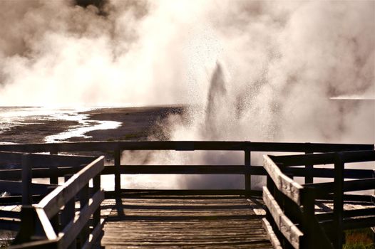 Black Sand Basin Yellowstone National Park. Erupting Geyser in Front of View Point. U.S. National Parks Photo Collection