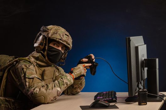soldier sitting at a computer is conducting a cyber war