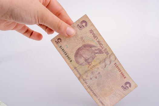 Hand holding 5 Turksh Lira banknote  in hand