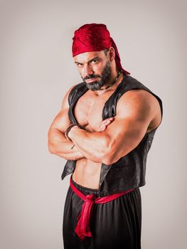 Muscular man in genie costume in studio