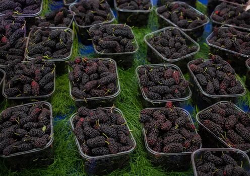 Black mulberries in plastic packages on sale