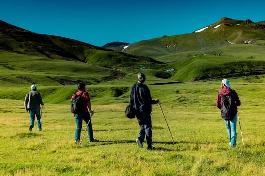 hikers with backpacks and trekking poles walking in Artvin highland