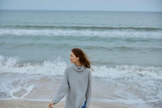 pretty woman alone by the ocean cloudy weather Happy female relaxing. High quality photo