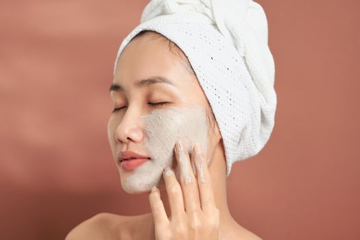 Spa Woman applying Facial clay Mask. Beauty Treatments. 