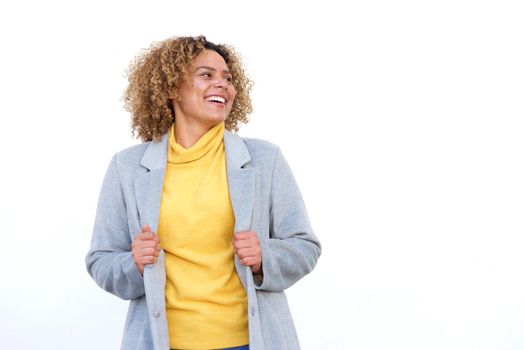 happy young african american woman laughing against white background with coat