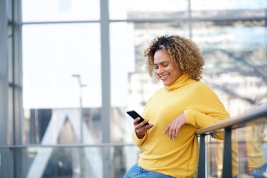 attractive african american woman looking at mobile phone