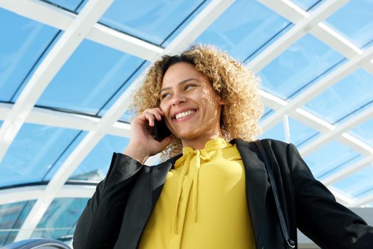 confident businesswoman talking with mobile phone 