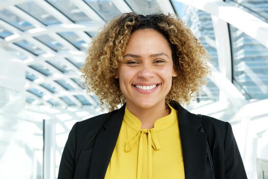 horizontal portrait of smiling businesswoman with curly hair