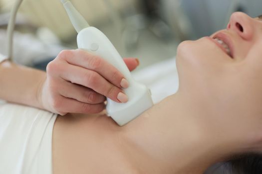 Ultrasound scanning diagnostic for woman of thyroid gland in hospital