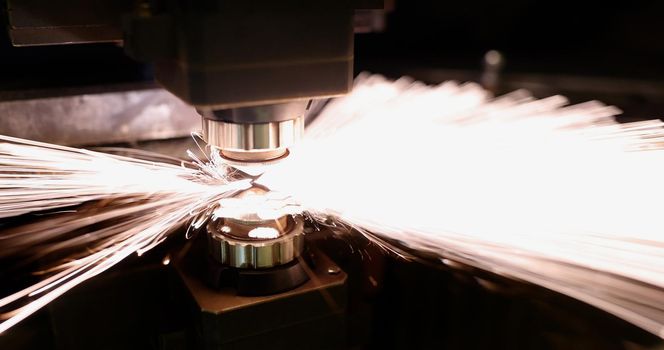Neon sparks fly of machine head for metal processing laser metal