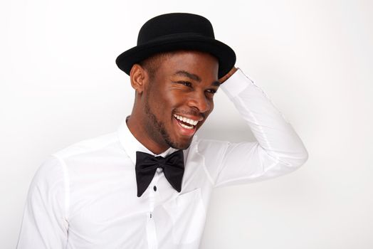 Candid portrait of happy man laughing with bowtie and hat