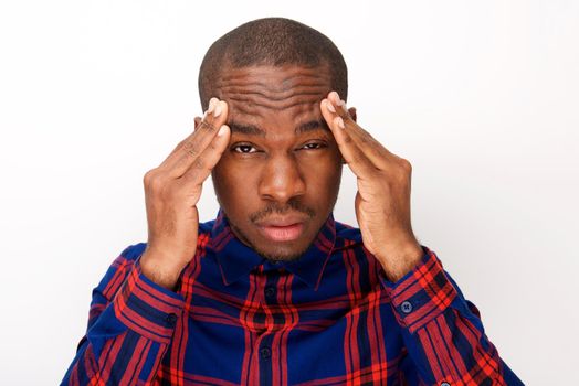 Close up of young black man with headache and fingers pressing against head