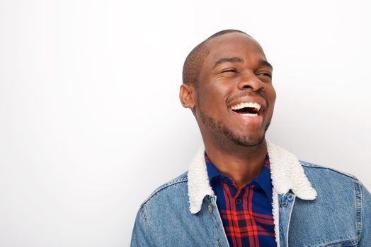 happy african american man laughing with denim jacket against white background